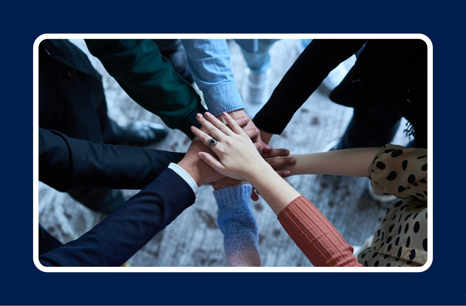 Hands overlapping in middle of team meeting