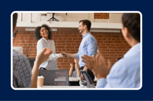 man shaking hands with woman to celebrate her receiving a promotion