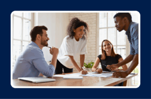 A diverse IT team collaborating around a conference table, highlighting essential soft skills in IT roles such as communication, teamwork, and problem-solving.