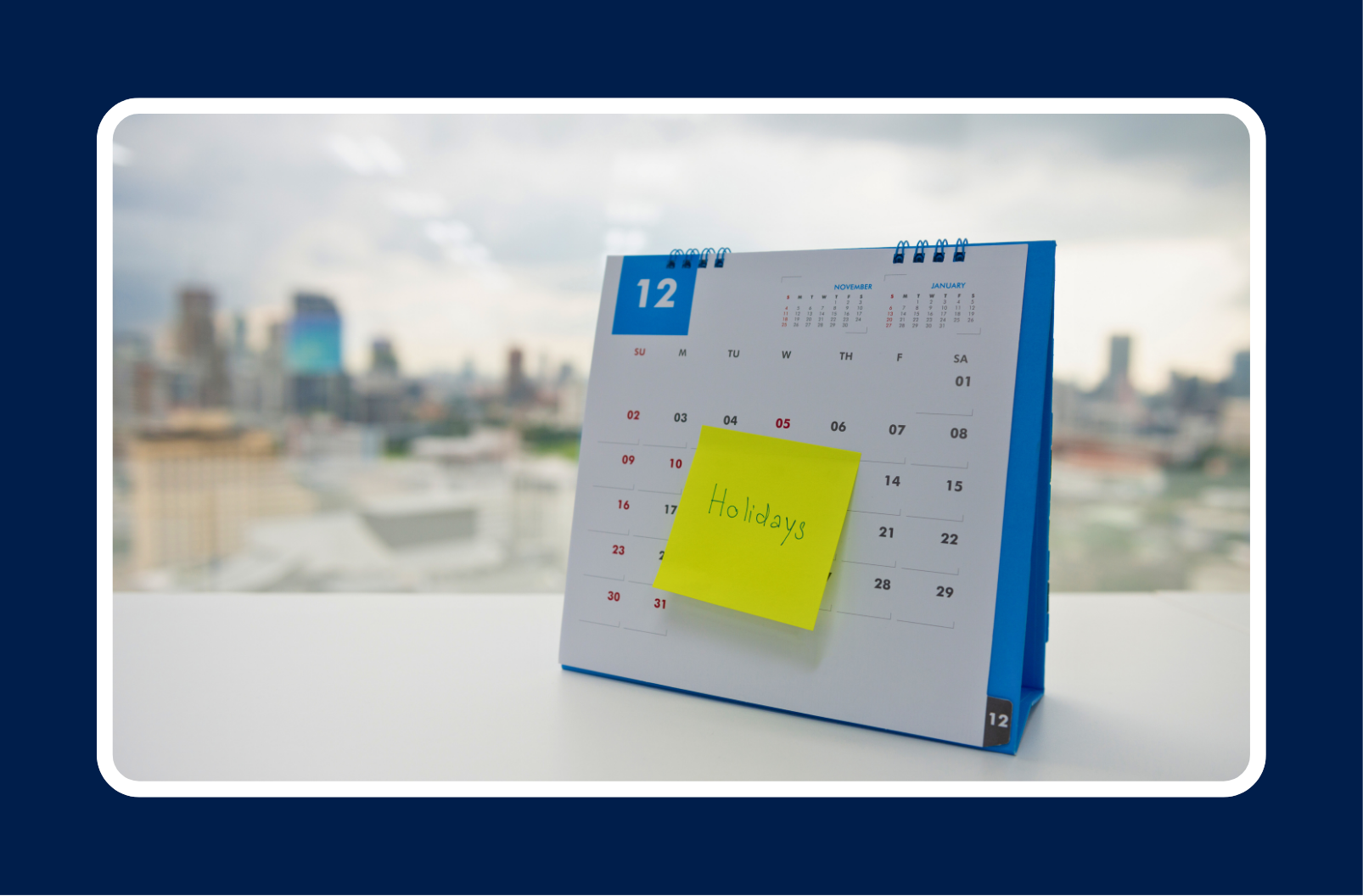 A December desk calendar marked with a sticky note reading “Holidays,” symbolizing year-end job search planning and staying visible during the holiday season.