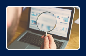 Magnifying glass over a laptop screen representing how job seekers use LinkedIn job search filters to find roles.