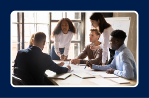 A team collaborating in a meeting, representing the transition from individual contributor to people leader through collaboration and shared decision-making.