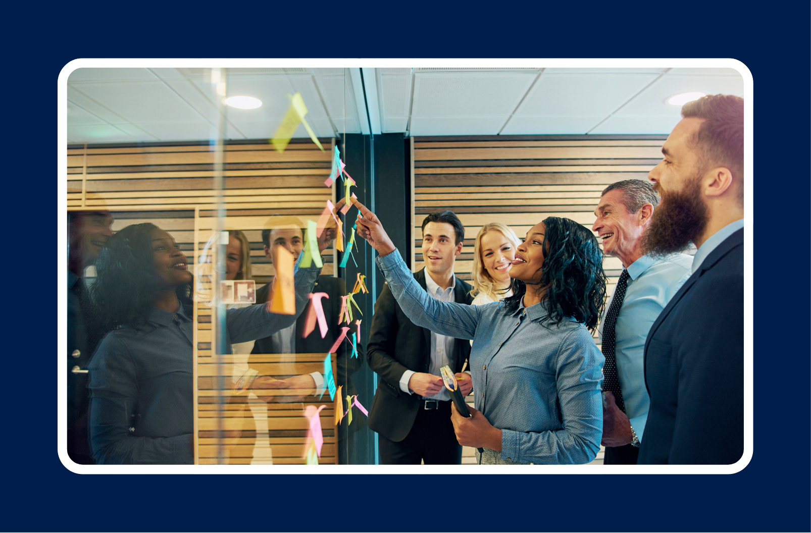 Team collaborating on a strategy board demonstrating cross-functional communication for technical leaders across engineering, product, and business teams.