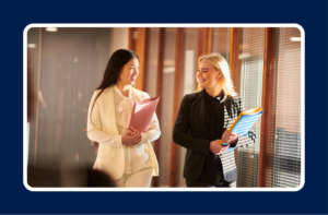 Business professionals collaborating in an office, illustrating when to partner with a recruiting firm to build stronger teams.